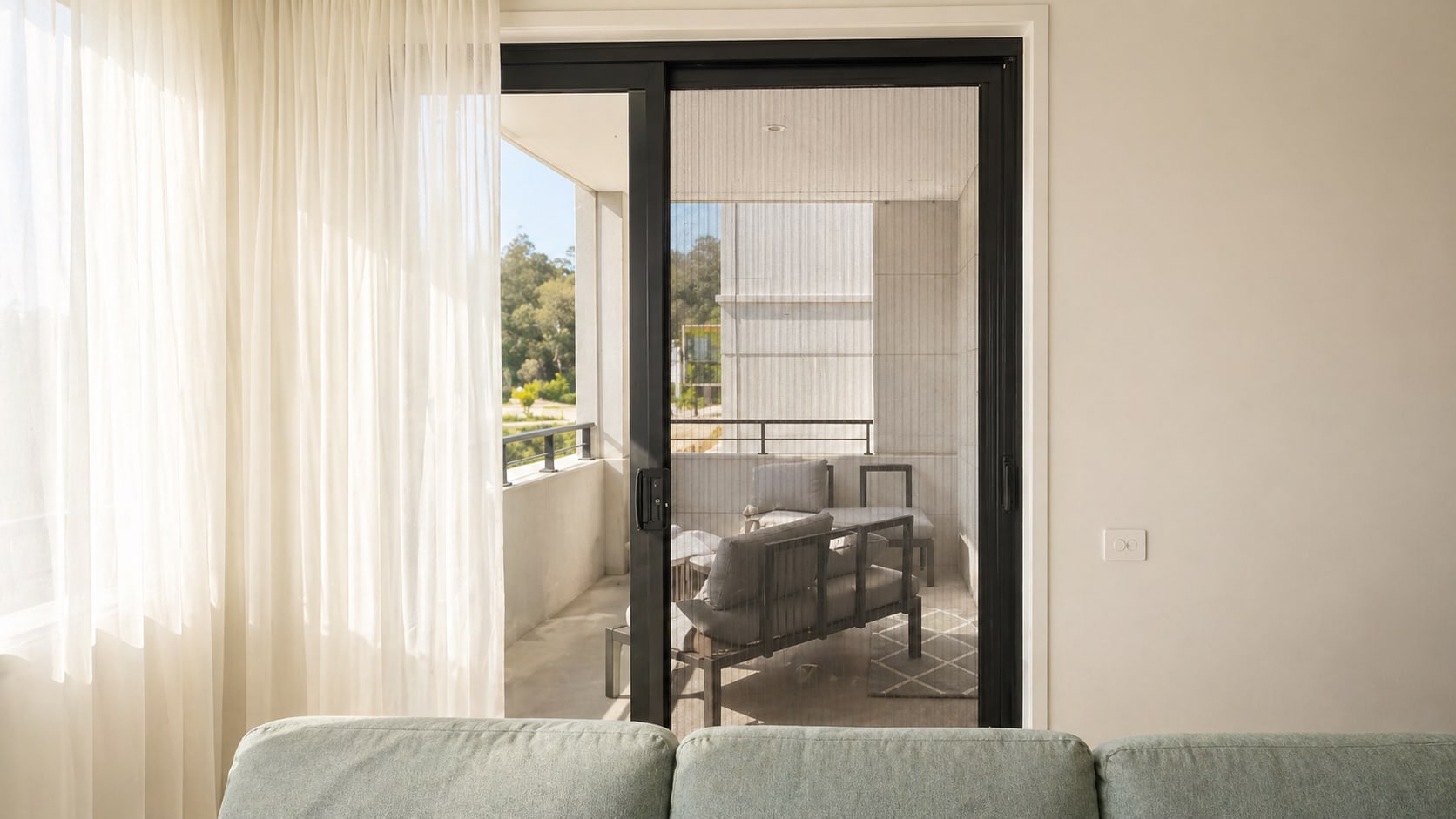 Retractable fly screen fitted to a bright modern doorway
